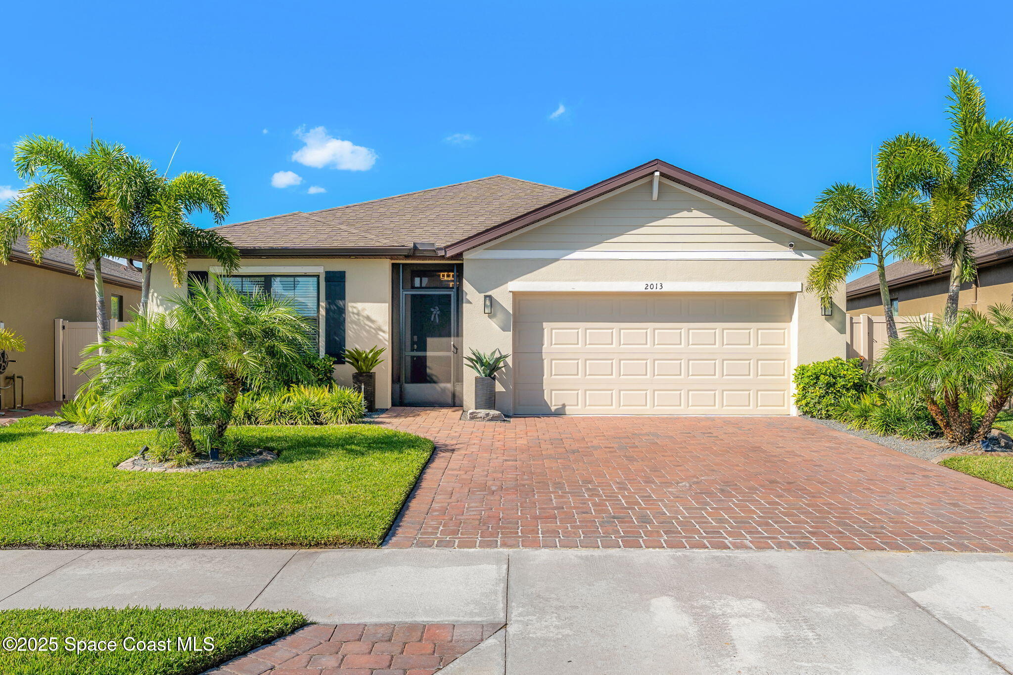 2013 Farmhouse Road Southeast Palm Bay, FL 32909 - Photo 4 of 37 a front view of a house with a yard