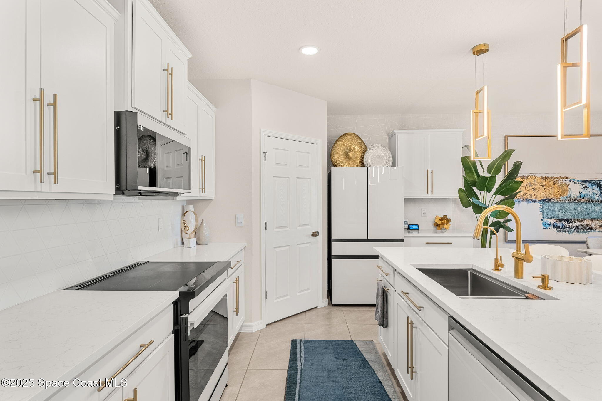 2013 Farmhouse Road Southeast Palm Bay, FL 32909 - Photo 8 of 37 a kitchen with a sink a stove and cabinets