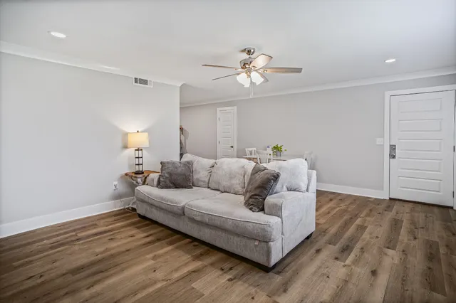 a living room with furniture and wooden floor