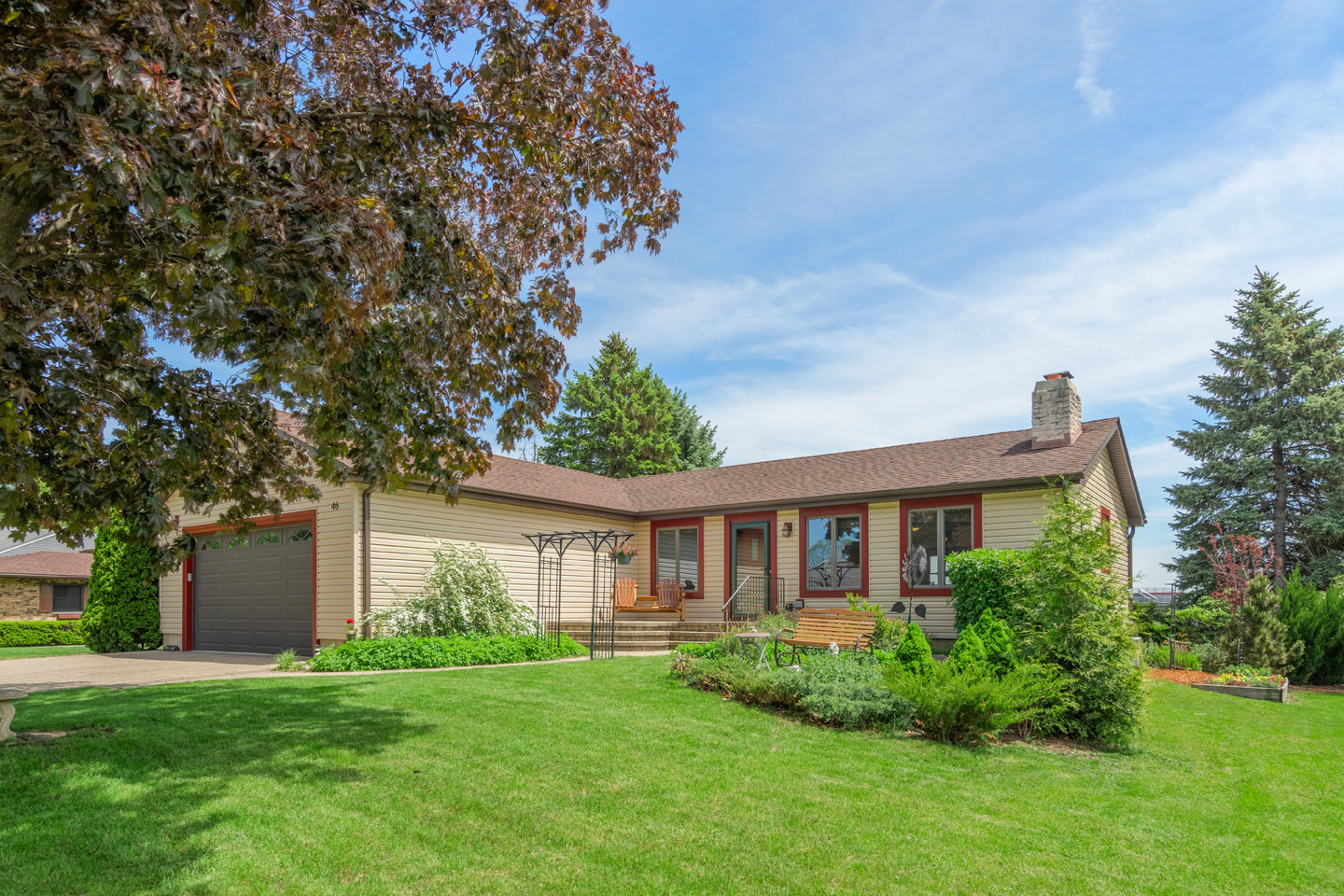 a view of a house with a yard and a garden