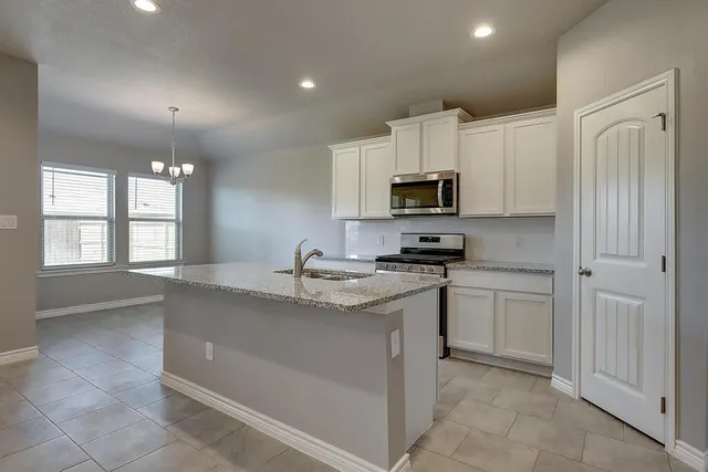a kitchen with a sink stove and microwave