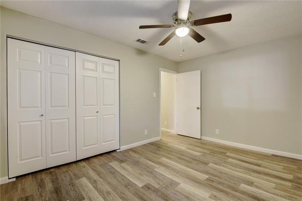 2311 Teri Road, Unit B Austin, TX 78744 - Photo 18 of 25 wooden floor in an empty room