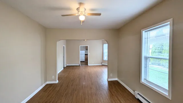 wooden floor in an empty room with a window