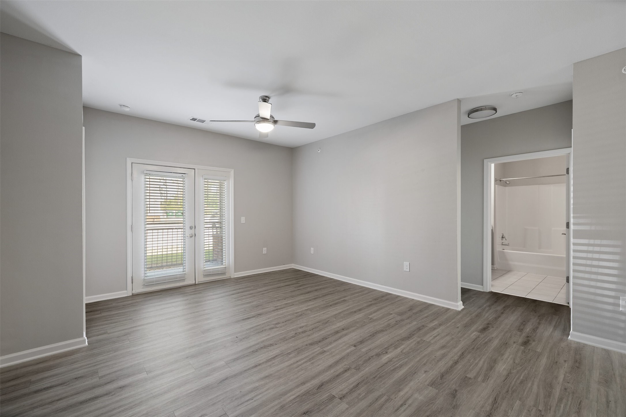 4101 5th Avenue Lake Charles, LA 70607 - Photo 4 of 16 a view of an empty room with wooden floor and a window