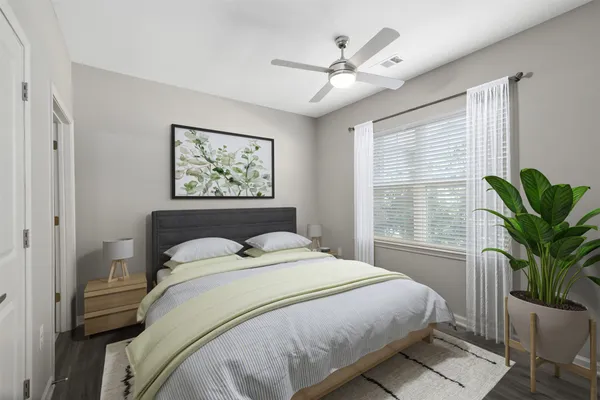 a bedroom with a large bed and a window