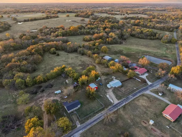 an aerial view of a house with a yard