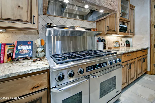 a bathroom with a granite countertop toilet a sink and mirror