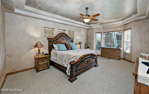 a bathroom with a granite countertop double vanity sink and a mirror