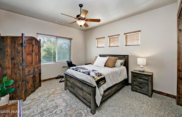a view of a patio with table and chairs potted plants and large tree