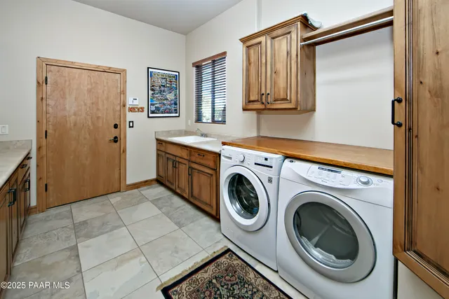 a view of a patio with a dining table and chairs with a barbeque grill