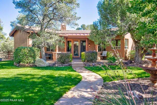 a table and chairs with the view of outdoor space