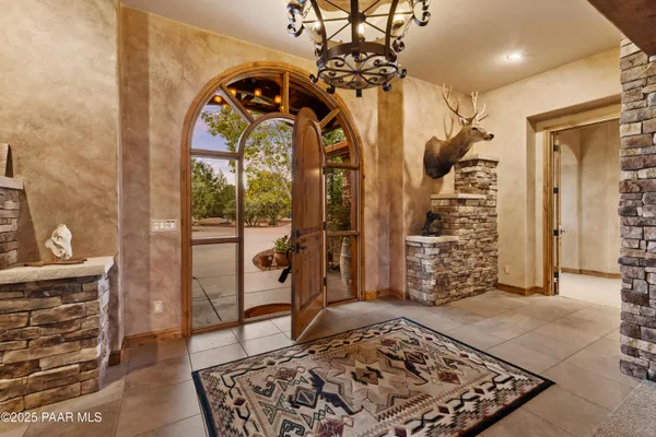 a living room with furniture a fireplace and a floor to ceiling window