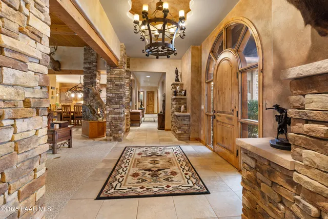 a living room with fireplace furniture and a large window