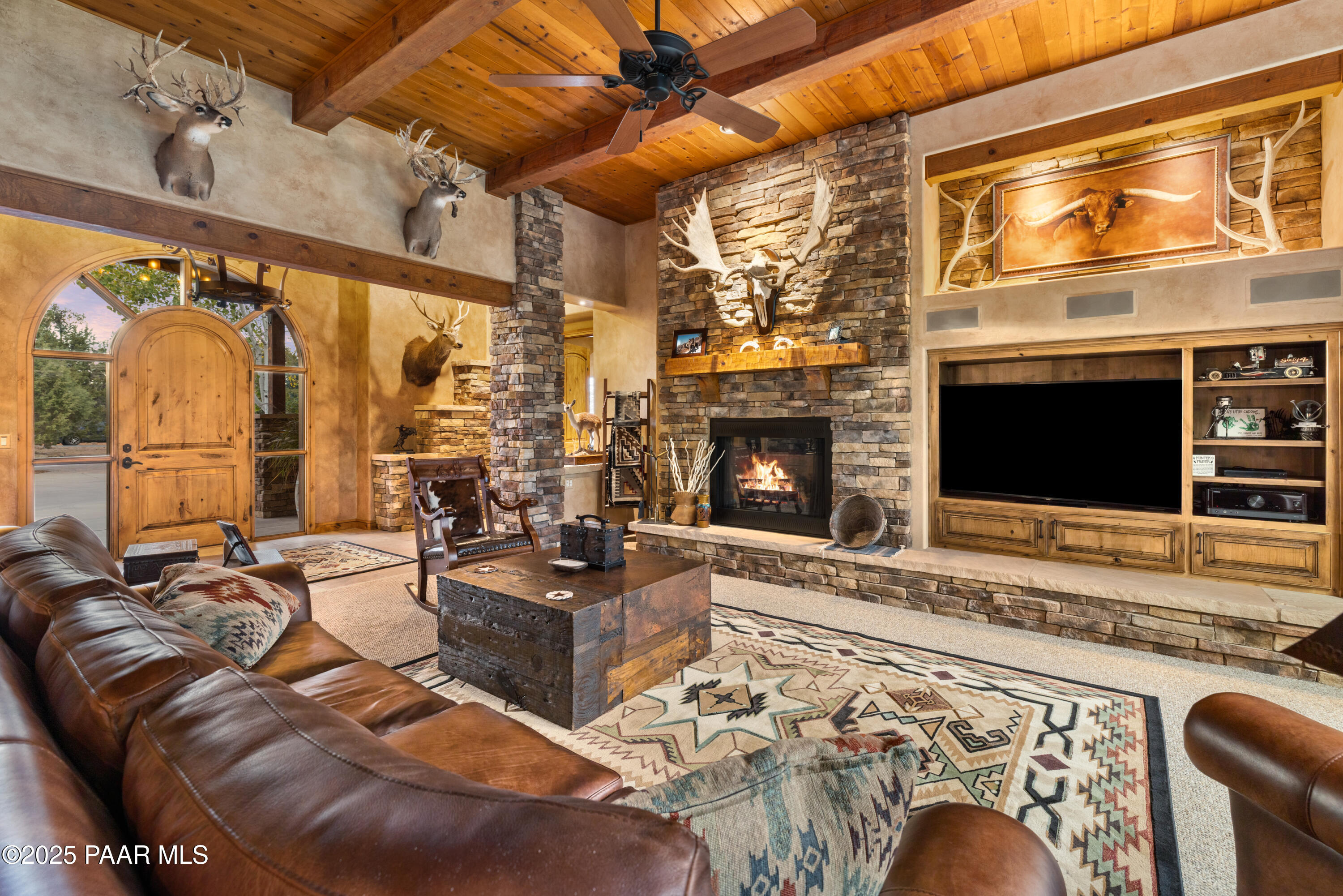 5110 Indian Camp Road Prescott, AZ 86305 - Photo 6 of 79 a living room with furniture a fireplace and a flat screen tv