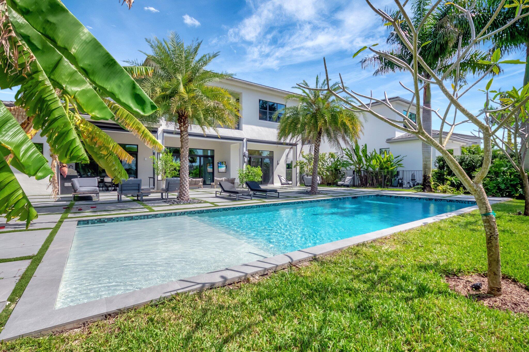 17353 Rosella Road Boca Raton, FL 33496 - Photo 74 of 103 a view of swimming pool with outdoor seating and a garden