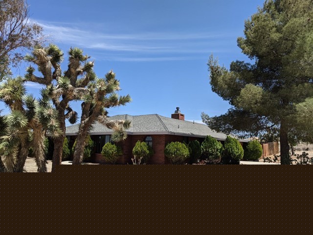 11175 Primavera Road Pinon Hills, CA 92372 - Photo 1 of 1 a view of a street with a building in the background