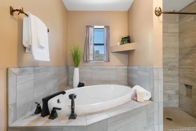a bathroom with a tub and a shower