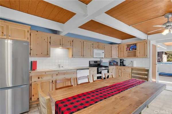 a kitchen with stainless steel appliances granite countertop a refrigerator sink and cabinets