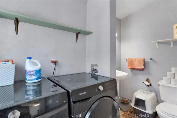 a bathroom with a sink toilet and a mirror