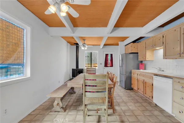 a kitchen with a table chairs and a stove