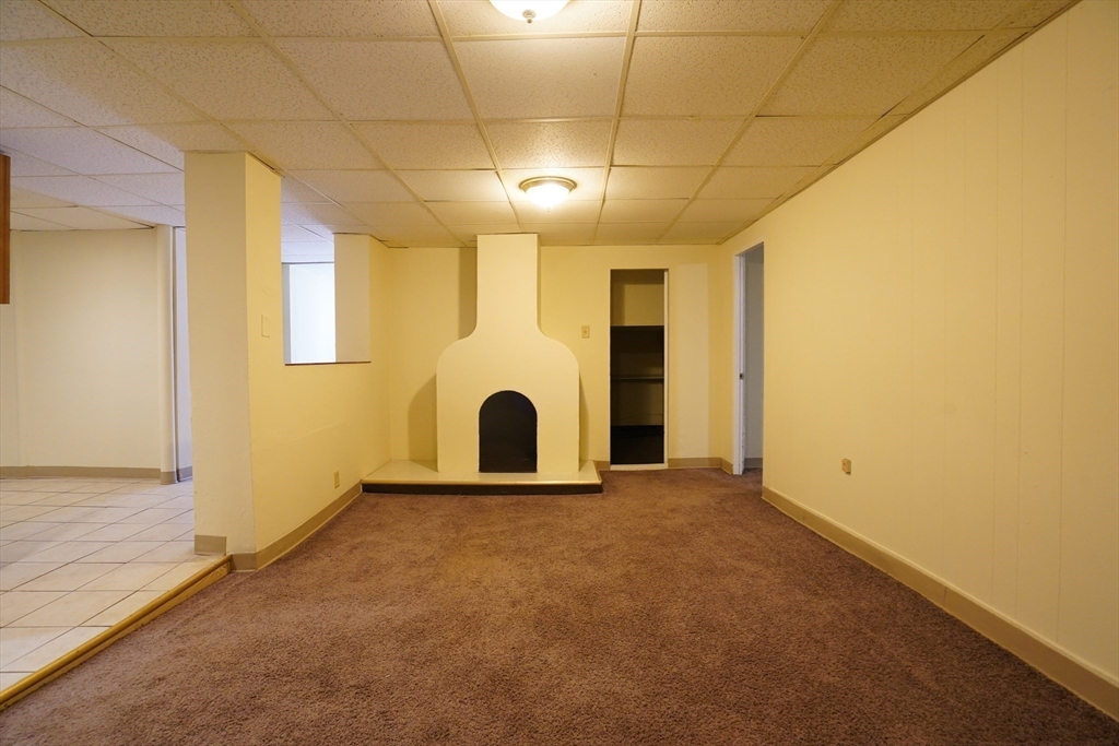 a view of an empty room with a fireplace