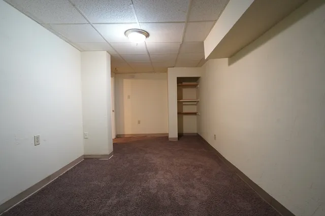 an empty room with closet area