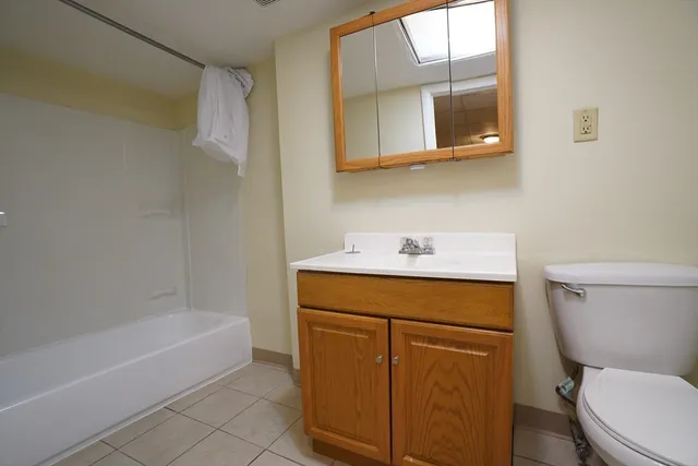 a bathroom with a sink a toilet and bathtub