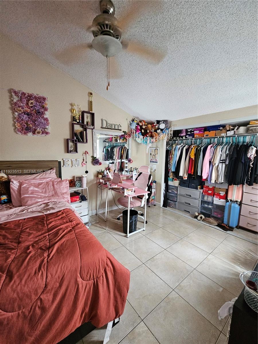 8401 West Sample Road, Unit 10 Coral Springs, FL 33065 - Photo 14 of 17 a bedroom with furniture and a bed