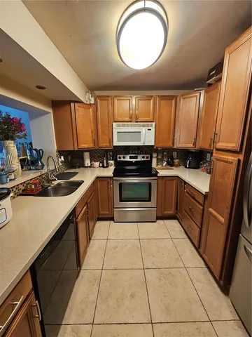 a kitchen with stainless steel appliances granite countertop a stove sink and cabinets