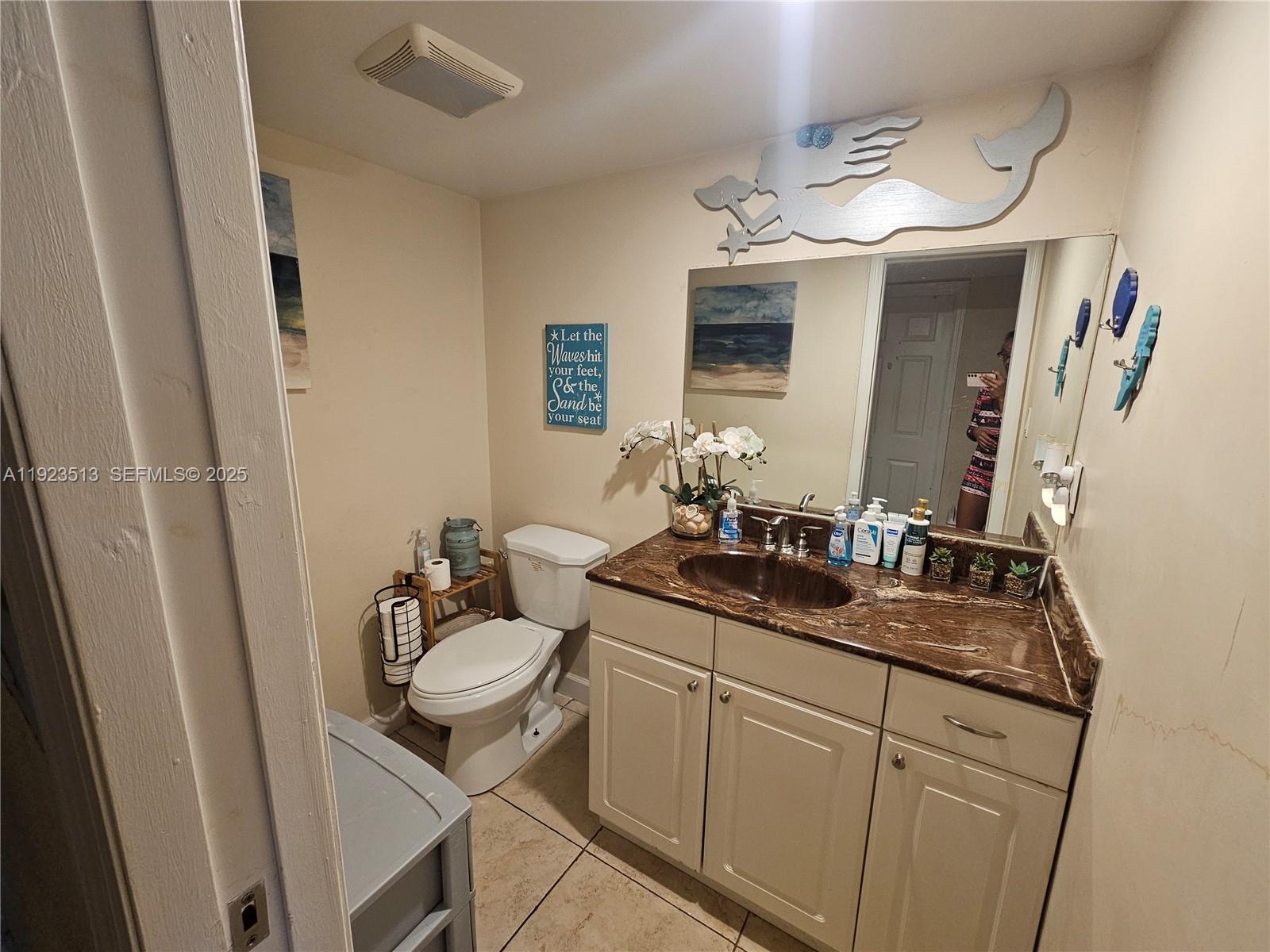 8401 West Sample Road, Unit 10 Coral Springs, FL 33065 - Photo 8 of 17 a bathroom with a granite countertop sink and a mirror
