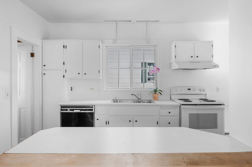 2 Lindsey Street Marblehead, MA 01945 - Photo 7 of 19 a kitchen with stainless steel appliances granite countertop a stove a sink and white cabinets