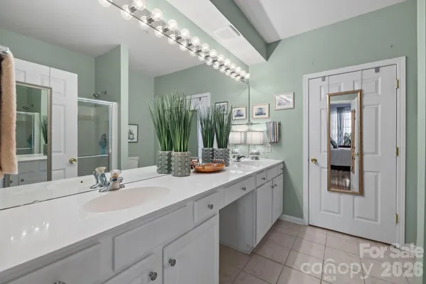 a bathroom with a double vanity sink and a mirror