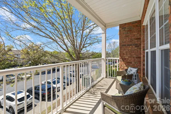 a view of a balcony with furniture