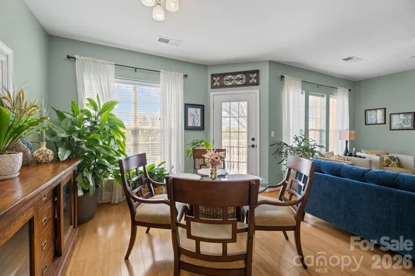 a dining room with furniture and wooden floor