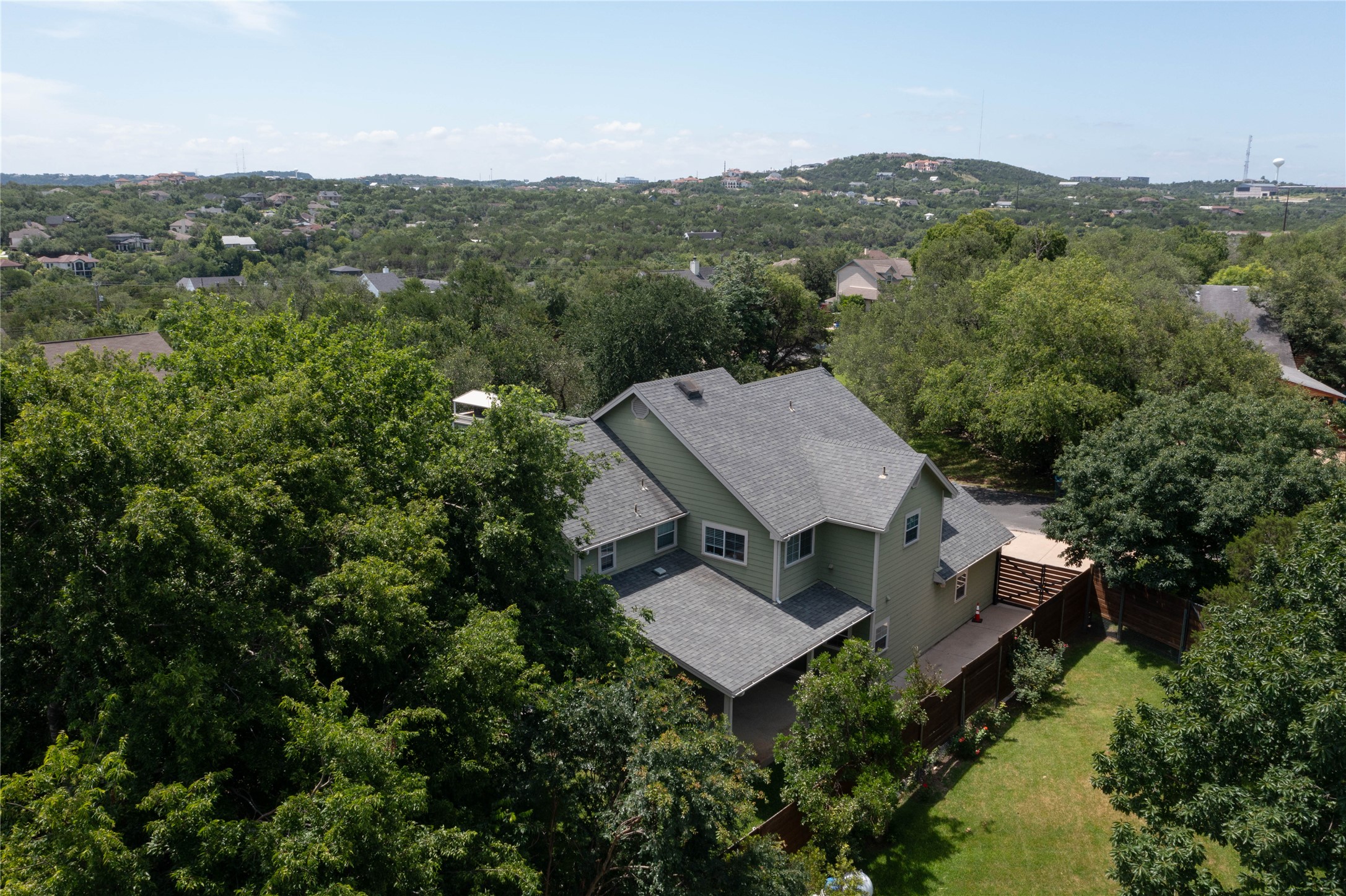1204 Orlando Road Austin, TX 78733 - Photo 30 of 40 An aerial perspective reveals a private hillside dwelling nestled among mature trees with commanding distant views.