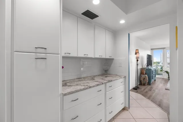 a kitchen with granite countertop a sink stainless steel appliances and cabinets