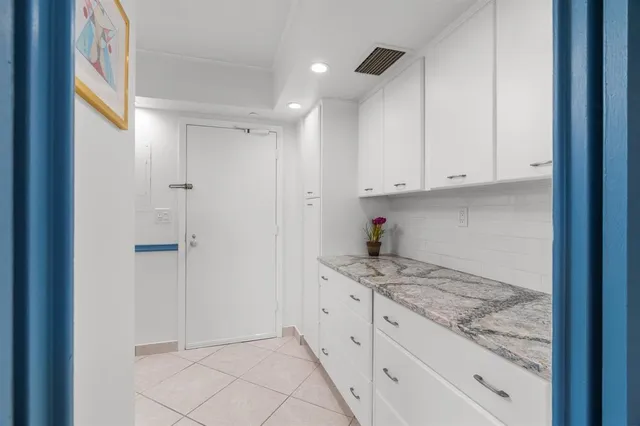 a kitchen with cabinets stainless steel appliances and a counter top space