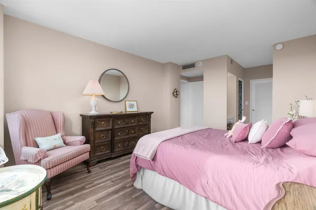 a bedroom with two beds and painting on the wall