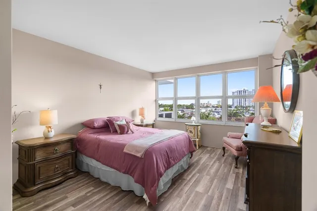 a bedroom with a large bed and a large window