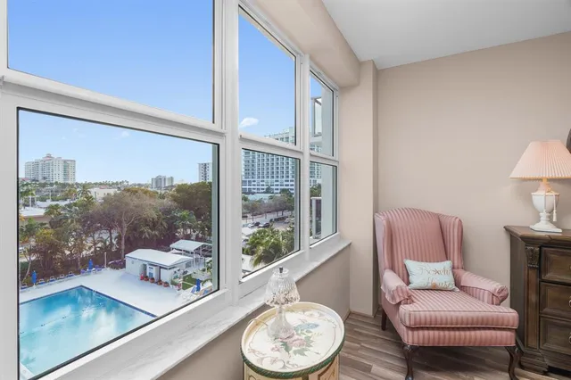 a bedroom with two beds and large window