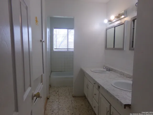 a bathroom with a sink a vanity and a mirror