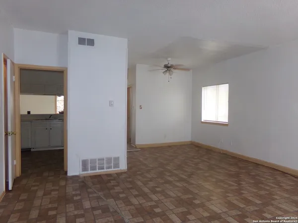 an empty room with windows and closet