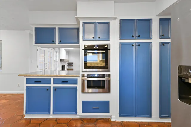 a kitchen with stainless steel appliances granite countertop a stove and a refrigerator