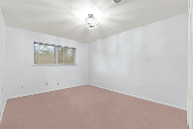 a view of an empty room with a fan