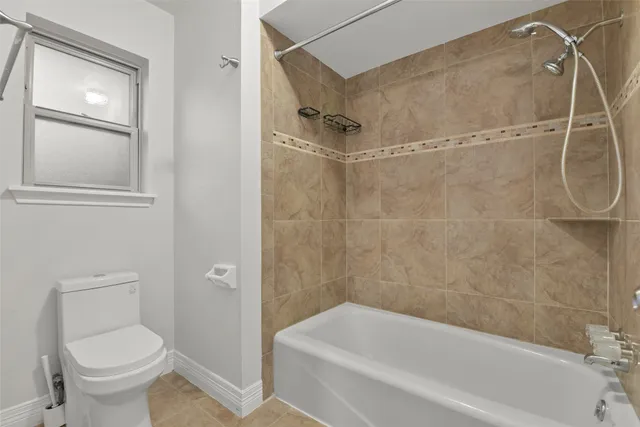 a bathroom with a toilet and a bathtub