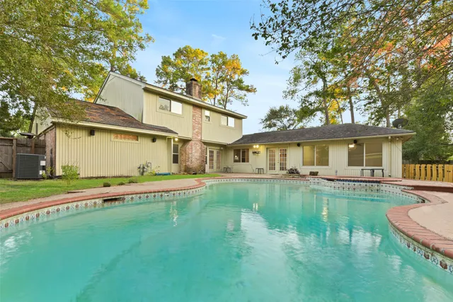 a front view of a house with swimming pool having outdoor seating