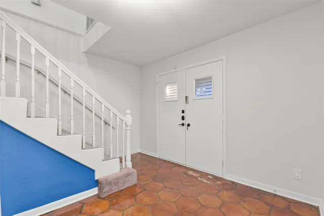 a view of an entryway with wooden floor