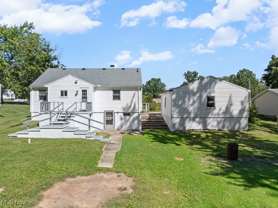 1702 Far View Road Akron, OH 44312 - Photo 39 of 49 Back of property with a yard and a shingled roof