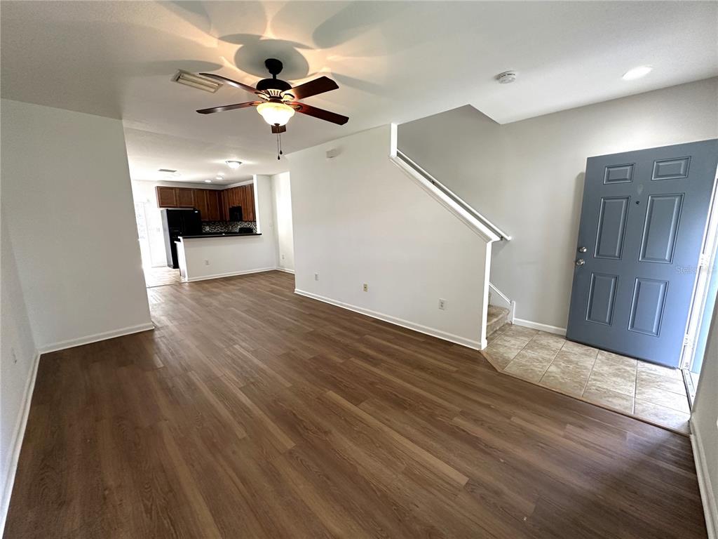 15816 Fishhawk View Drive Lithia, FL 33547 - Photo 12 of 30 a view of an empty room with wooden floor and a ceiling fan