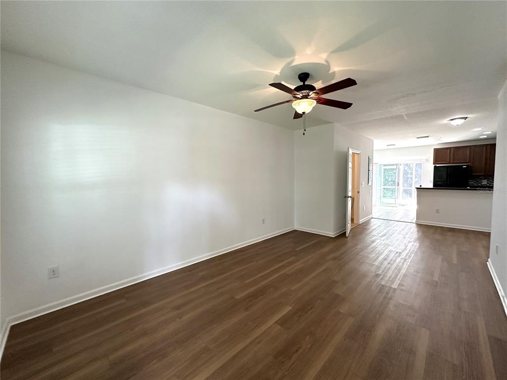 15816 Fishhawk View Drive Lithia, FL 33547 - Photo 5 of 30 a view of a kitchen with wooden floor and a ceiling fan